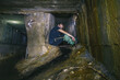 © Hennadii - The guy in the underground tunnel inside old sewer shaft
