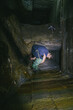 © Hennadii - The guy in the underground tunnel inside old sewer shaft