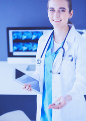 Wall Mural - Close-up shot of doctor's hands holding pills and tablet at clinic.