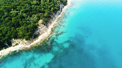 Wall Mural - Beach and sea, aerial top down view. Waves splashing beach sand.