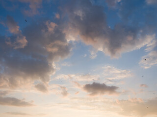 Whimsical clouds in the blue sky. Summer evening