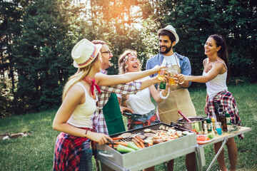 Friends having fun in nature doing bbq