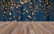© Syda Productions - holiday illumination and decoration concept - empty wooden surface or table with christmas golden lights on blue background