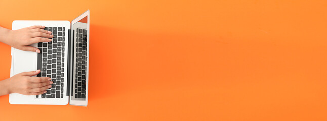 female hands with laptop on color background with space for text