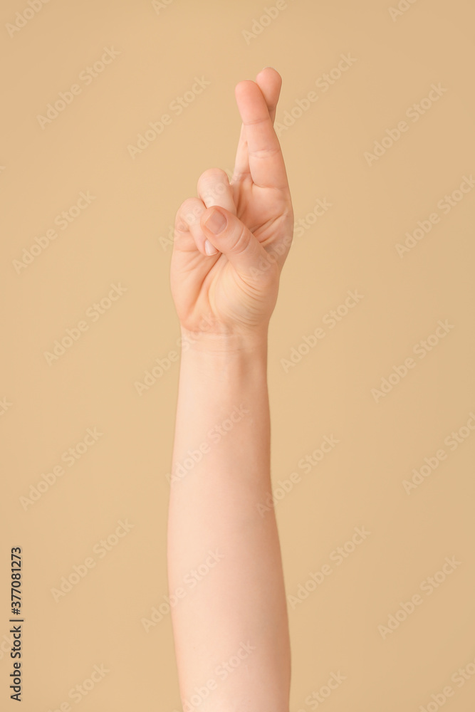 Hand showing letter R on color background. Sign language alphabet