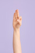 © Pixel-Shot - Hand showing letter F on color background. Sign language alphabet
