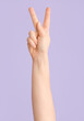 © Pixel-Shot - Hand showing letter K on color background. Sign language alphabet