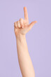 © Pixel-Shot - Hand showing letter L on color background. Sign language alphabet