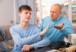 © JackF - Unhappy man scolding his teenage son at home interior