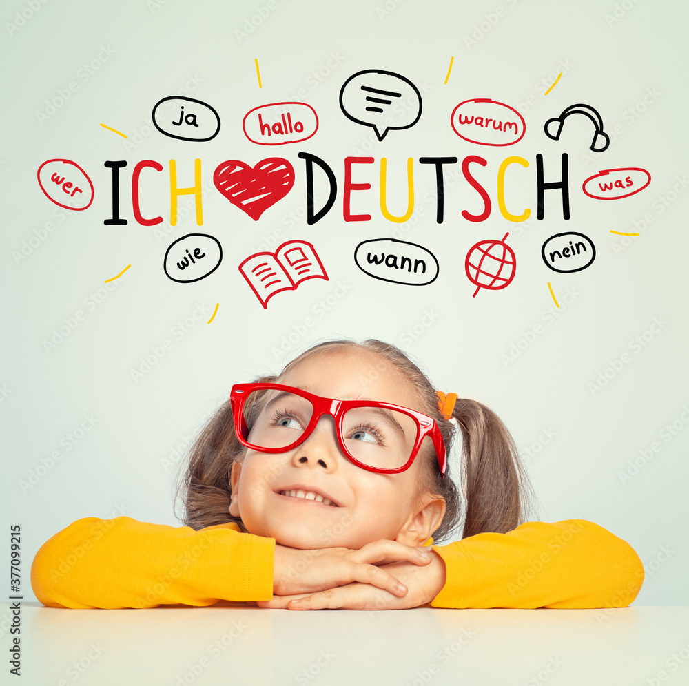 Beautiful cute little girl with eyeglasses looking at ich liebe deutch text and illustrations. English: i love german.  Foreign language learning concept.
 - obrazy, fototapety, plakaty 