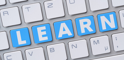 Wall Mural - a computer keyboard with the word learn