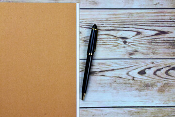 Wall Mural - Black pen on wooden boards, together with small brown colored notebooks