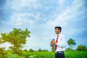 Indian man enjoys in nature with binoculars