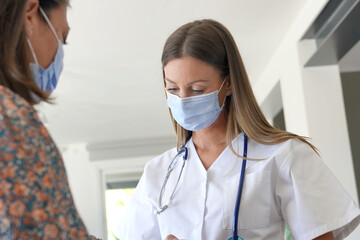 Wall Mural - Physiotherapist with patient, wearing face mask