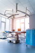 © Vadim - Clinic interior with operating surgery table, lamps and ultra modern devices, technology, hi-tech interior, medicine concept