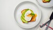 Poached egg avocado toast breakfast on white background overhead view