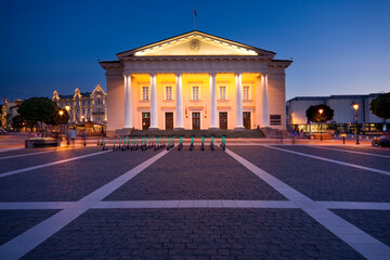 Wall Mural - Night view of illuminated Town Hall in the Town Hall Square in the Old Town of Vilnius, Lithuania