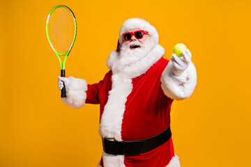 Wall Mural - Portrait of his he nice attractive cheerful cheery glad fat overweight Santa enjoying playing badminton physical activity isolated over bright vivid shine vibrant yellow color background