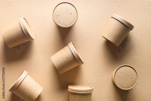 Pattern of eco-friendly disposable cardboard soup cups with shadow on brown paper background. Ecological individual package.