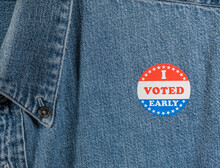 I Voted Early Sticker Or Campaign Button On The Blue Denim Working Shirt Collar For Elections In The USA