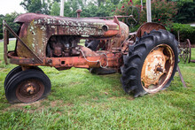 Old Rusty Tractor With Flat Tires. 