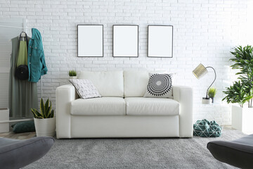 Poster - Stylish room interior with empty posters on white brick wall. Mockup for design