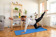 © mihajlo ckovric/Stocksy - Young man doing yoga at home