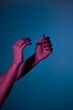 © Alberto Bogo/Stocksy - Conceptual Photo: Female Hand In pink Light