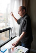 © JEFF WASSERMAN/Stocksy - Portrait of an Elderly Man Looing Out of Window
