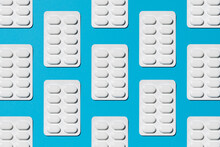 White Pills On Blue Background