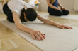 © mihajlo ckovric/Stocksy - Two adult women practice yoga in a yoga studio