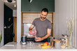 © mihajlo ckovric/Stocksy - Young man making smoothie in the kitchen