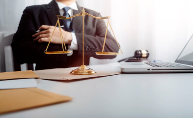 justice and law concept.Male judge in a courtroom on wooden table and Counselor or Male lawyer working in office. Legal law, advice and justice concept.