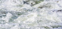 Rapid Spring River Flowing Over Rocks On Sunny Day, Forming White Water Waves, Closeup Detail - Abstract Nature Background