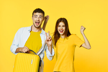 Wall Mural - A happy man and his girlfriend go on a trip with a suitcase 