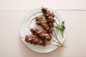 Lamb skewers on pink