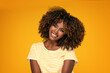 African afro woman with curly hair smiling.