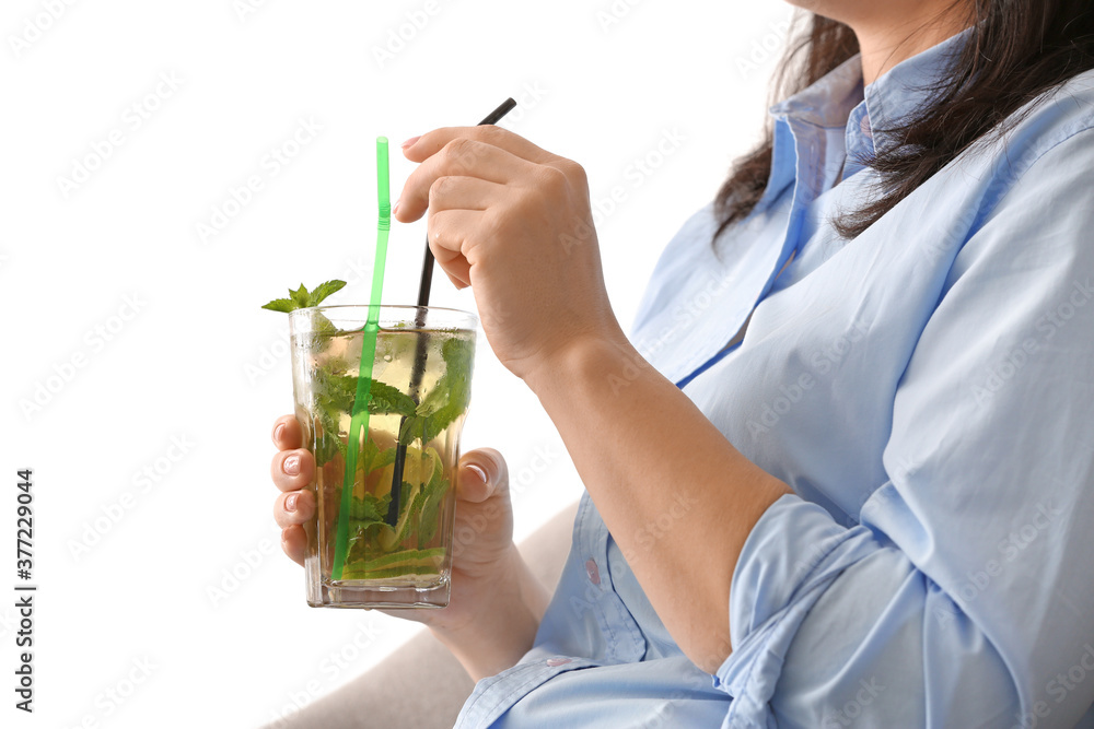 Woman drinking tasty cold ice tea at home