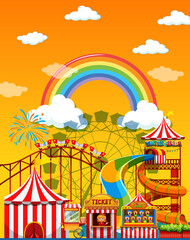 Wall Mural - Amusement park scene at daytime with rainbow in the sky