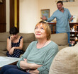 © JackF - Senior woman sitting during family conflict, woman crying while quarrel with man