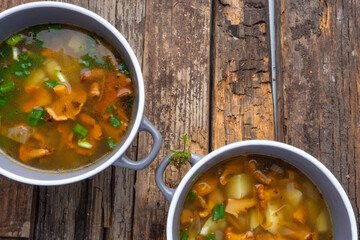 soup with chanterelles and herbs in two bowls