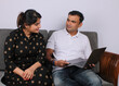 © Ojas - young Indian couple using the laptop sitting on a sofa.