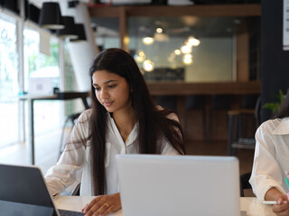 Businesswoman working on her project in modern office room