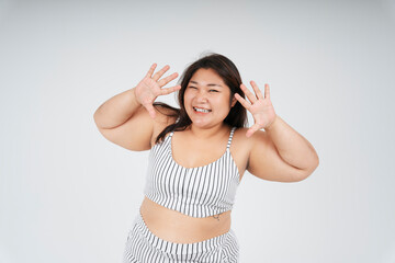 Cheerful healthy asian chubby woman showing two hands on white background.