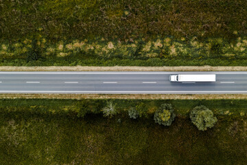 large freight transporter semi-truck on the road, aerial view