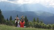© MEDIAIMAG - Parent sitting with back lift up children, mountains landscape, sun rays shining through white clouds, carefree lifestyle, enjoy nature peace