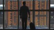 © MEDIAIMAG - Passenger at airport timetable departure flights gate