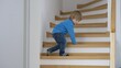 © MEDIAIMAG - Blond hair child learn to go go down stairs, develop new skills home