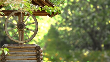 Rustic wooden traditional fountain in the orchard, beautiful countryside