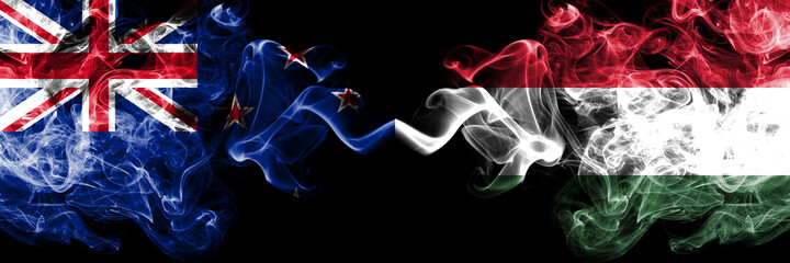 New Zealand vs Hungary, Hungarian smoky mystic flags placed side by side. Thick colored silky abstract smoke flags